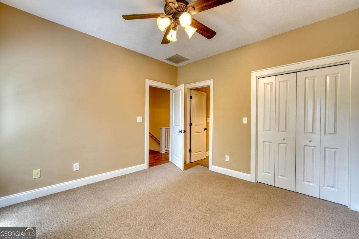 1401 Lakeside Road, Unit 502 Hiawassee, GA 30546 - Photo 31 of 46 an empty room with closet and chandelier fan