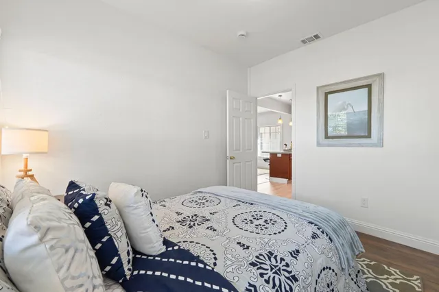 a bathroom with a granite countertop sink toilet a mirror a vanity and shower