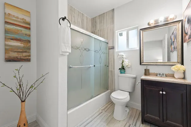 a bedroom with a bed and a view of kitchen