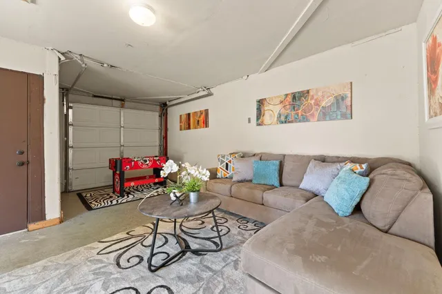 a living room with furniture potted plant and a potted plant