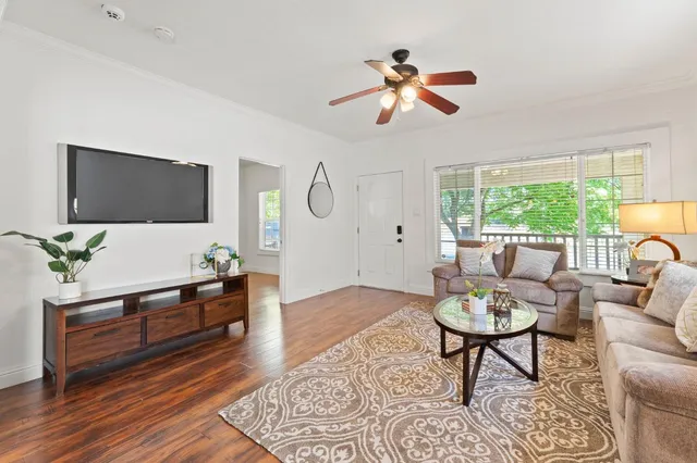 a living room with furniture and wooden floor