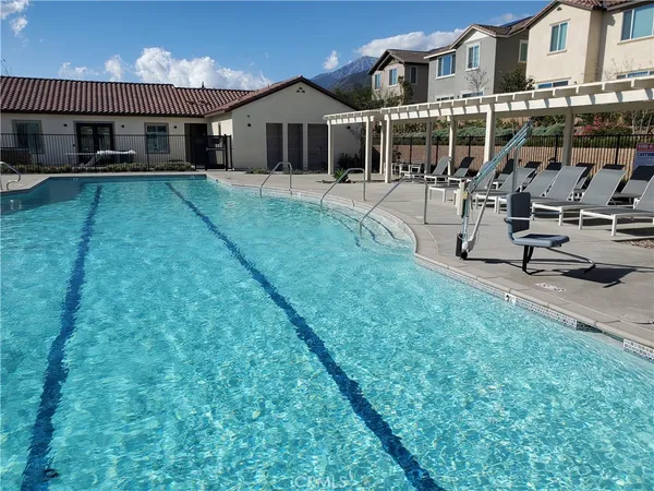 a front view of a house with swimming pool having outdoor seating