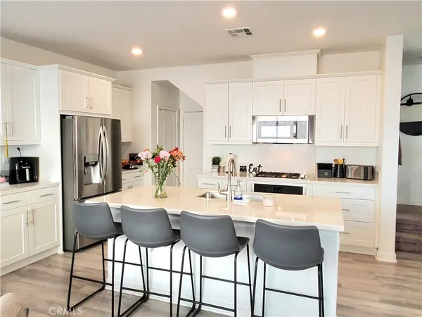 a kitchen with stainless steel appliances a refrigerator stove microwave and cabinets