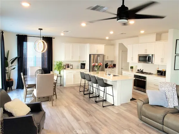 a living room with dining table furniture and kitchen view