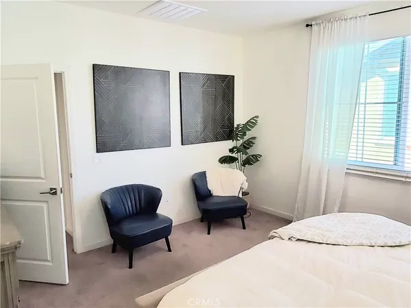 a bedroom with a bed and a chair