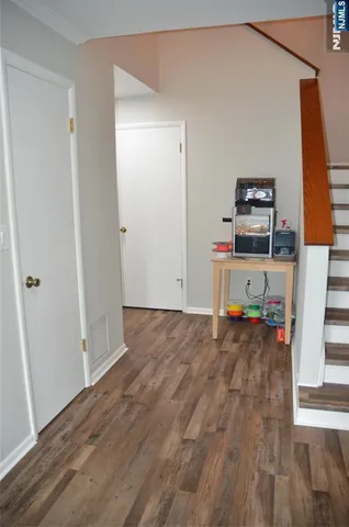 a living room with a fireplace and a wooden floor