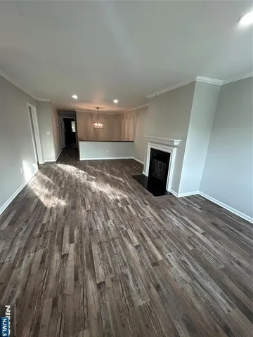 a hallway with a wooden floor and a window