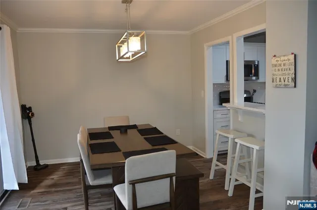 a bedroom with a bed a chandelier and a window