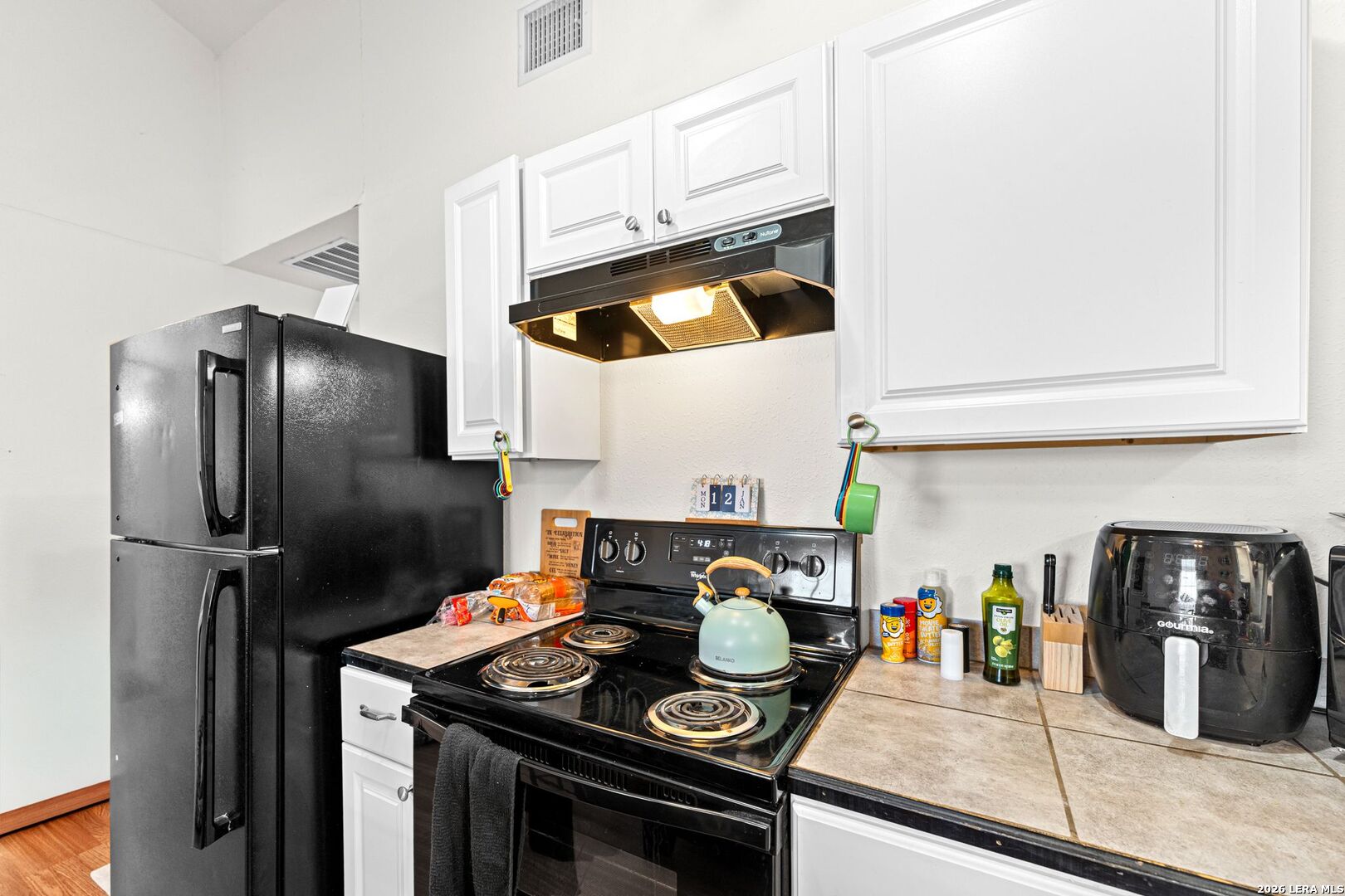 289 Chaparral Drive Bandera, TX 78003 - Photo 15 of 27 a kitchen with stainless steel appliances granite countertop a stove and a refrigerator
