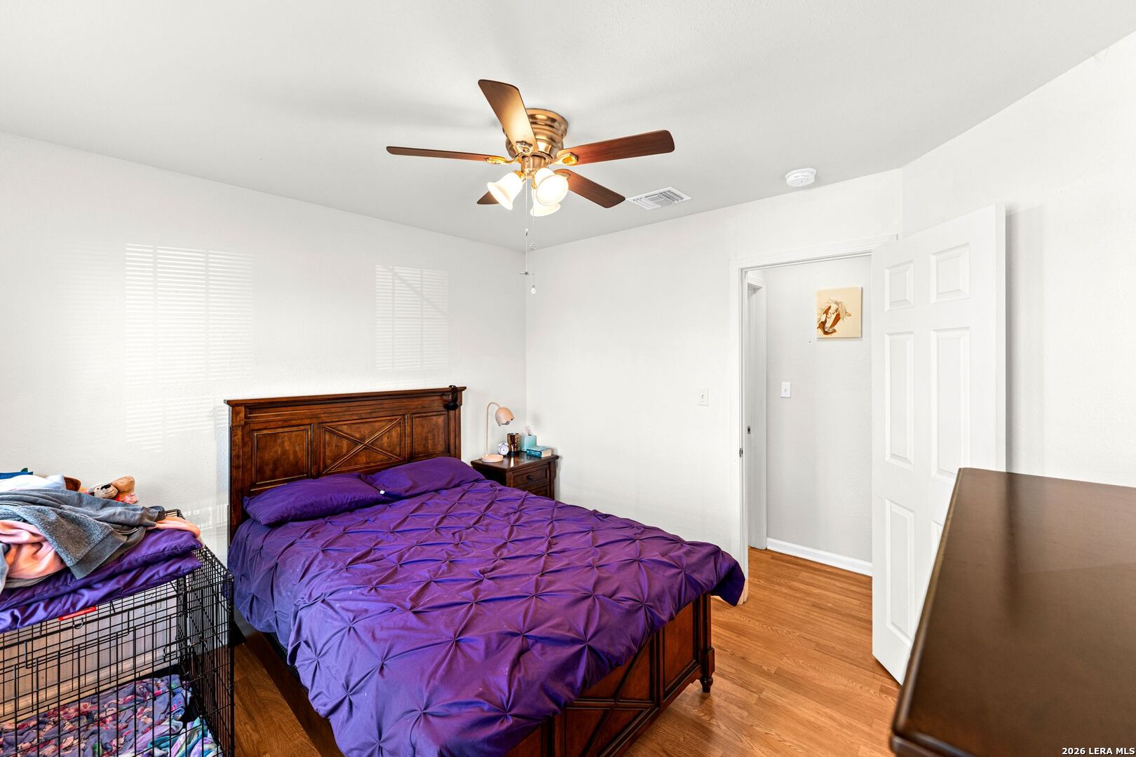 289 Chaparral Drive Bandera, TX 78003 - Photo 20 of 27 a bedroom with a bed and wooden floor