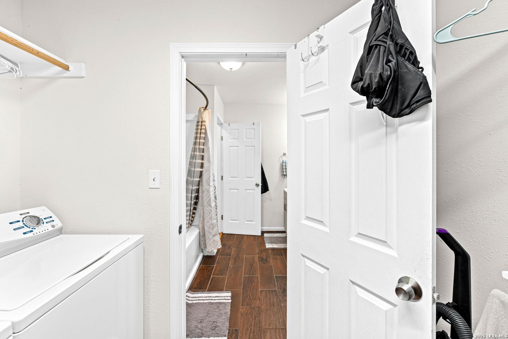 289 Chaparral Drive Bandera, TX 78003 - Photo 26 of 27 a walk in closet with wooden floor washer and dryer