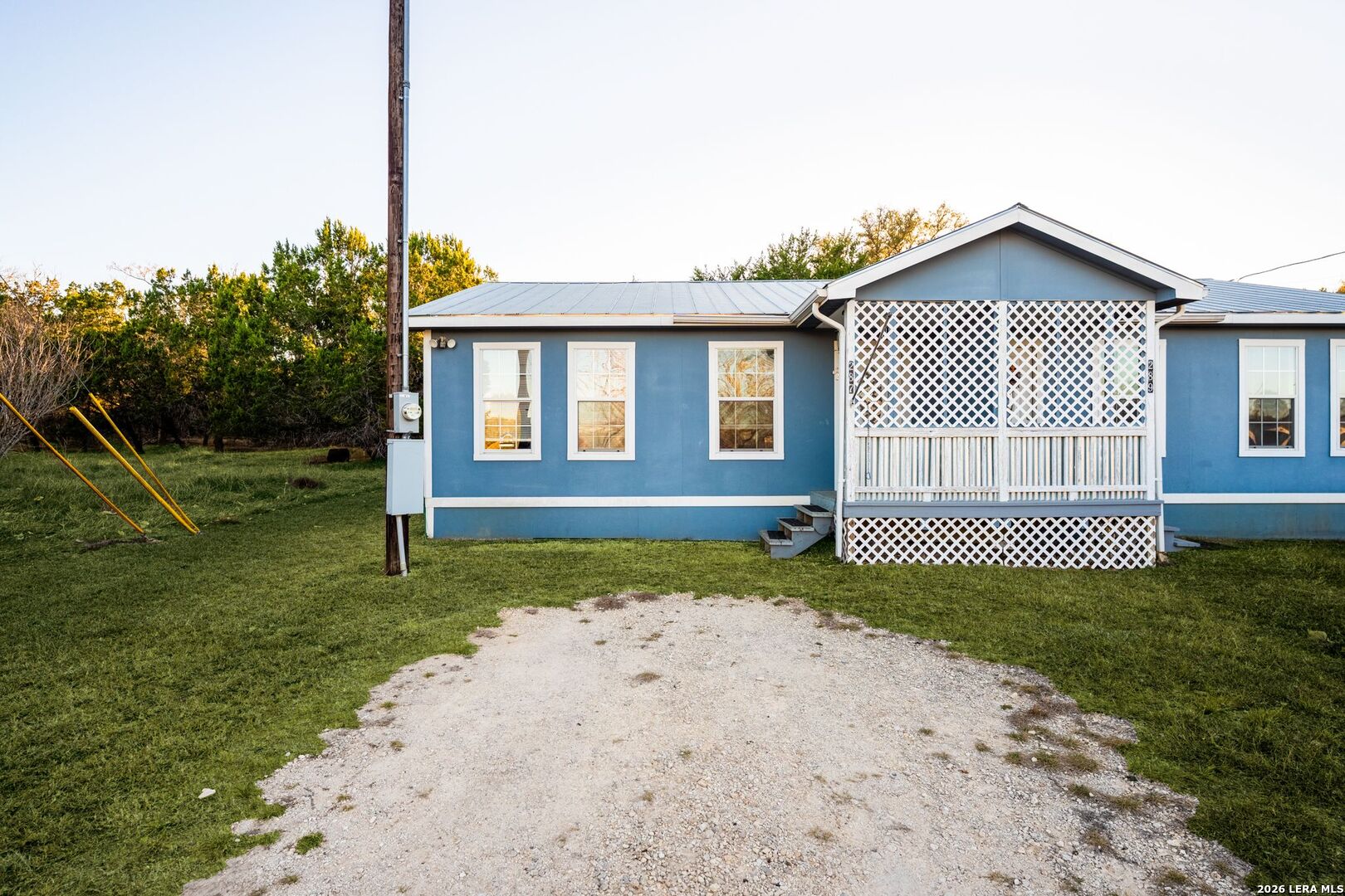 289 Chaparral Drive Bandera, TX 78003 - Photo 6 of 27 a front view of a house with garden