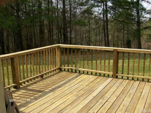 100 Lester Burch Road Roxboro, NC 27574 - Photo 3 of 3 a view of balcony with wooden floor and large trees