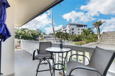 a view of a patio with table and chairs