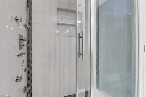 a bathroom with a glass shower door