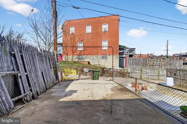 front view of a brick house with a yard
