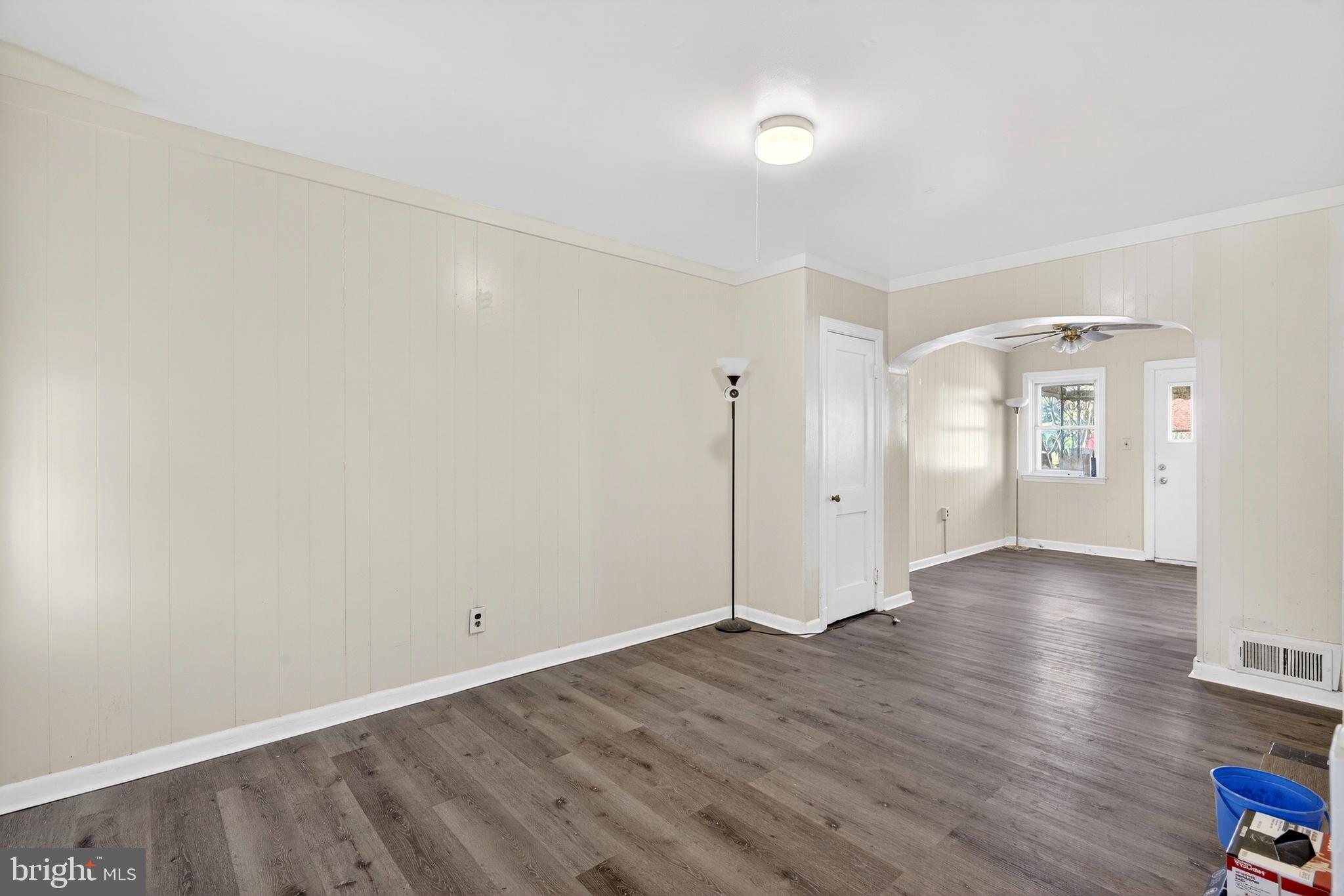 528 Sunset Road Baltimore, MD 21223 - Photo 4 of 27 an empty room with wooden floor and windows