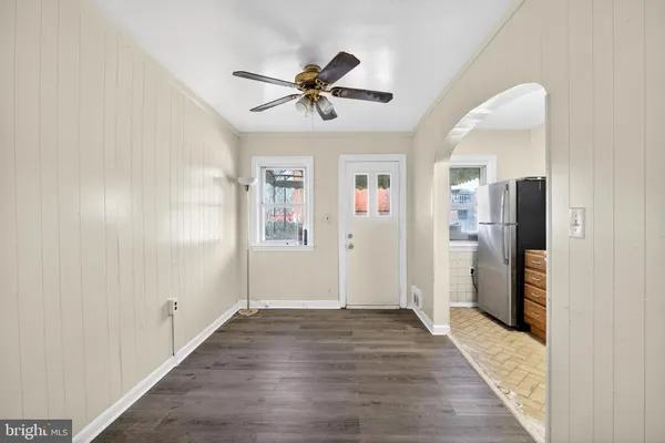 a view of empty room with wooden floor and window