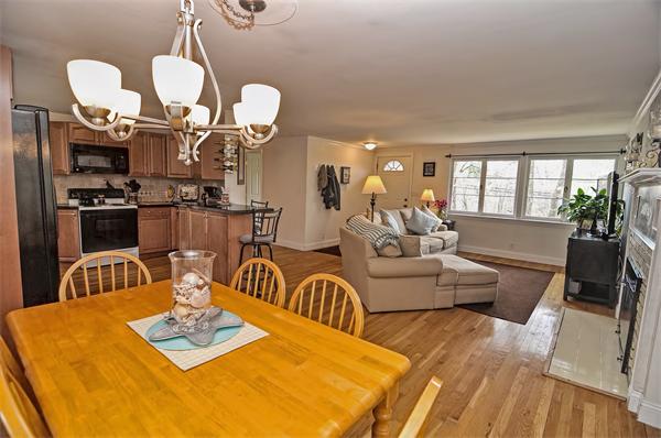 272 Main Street Norfolk, MA 02056 - Photo 11 of 29 a living room with dining table furniture and a chandelier