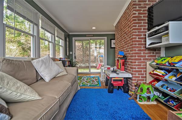 272 Main Street Norfolk, MA 02056 - Photo 13 of 29 a living room filled with furniture and a baby crib