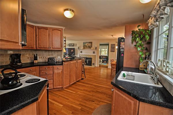 272 Main Street Norfolk, MA 02056 - Photo 4 of 29 a kitchen with granite countertop a sink a counter space stove and cabinets
