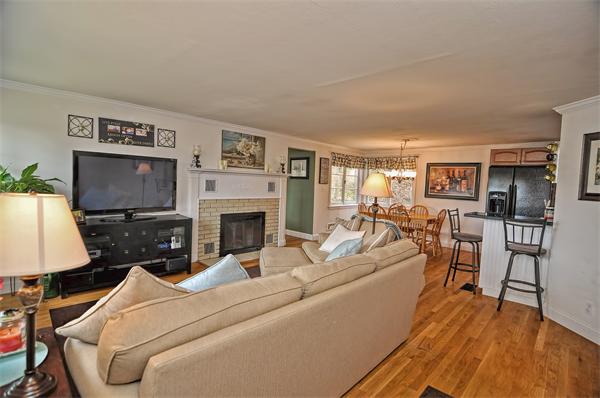 272 Main Street Norfolk, MA 02056 - Photo 8 of 29 a living room with furniture a flat screen tv and a fireplace