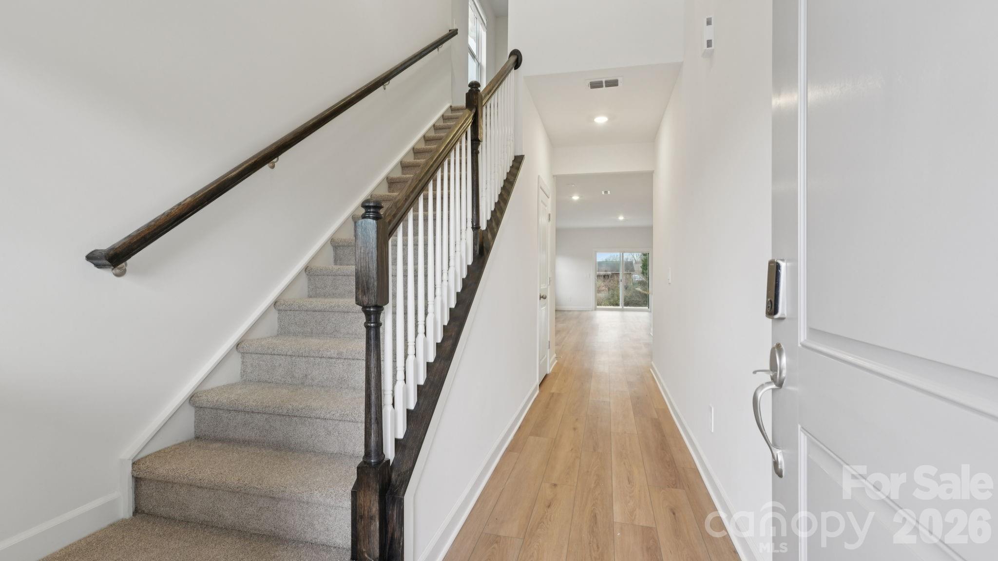 1273 30th St Lane Northeast Conover, NC 28613 - Photo 2 of 21 a view of staircase with lots of frames on wall and wooden floor