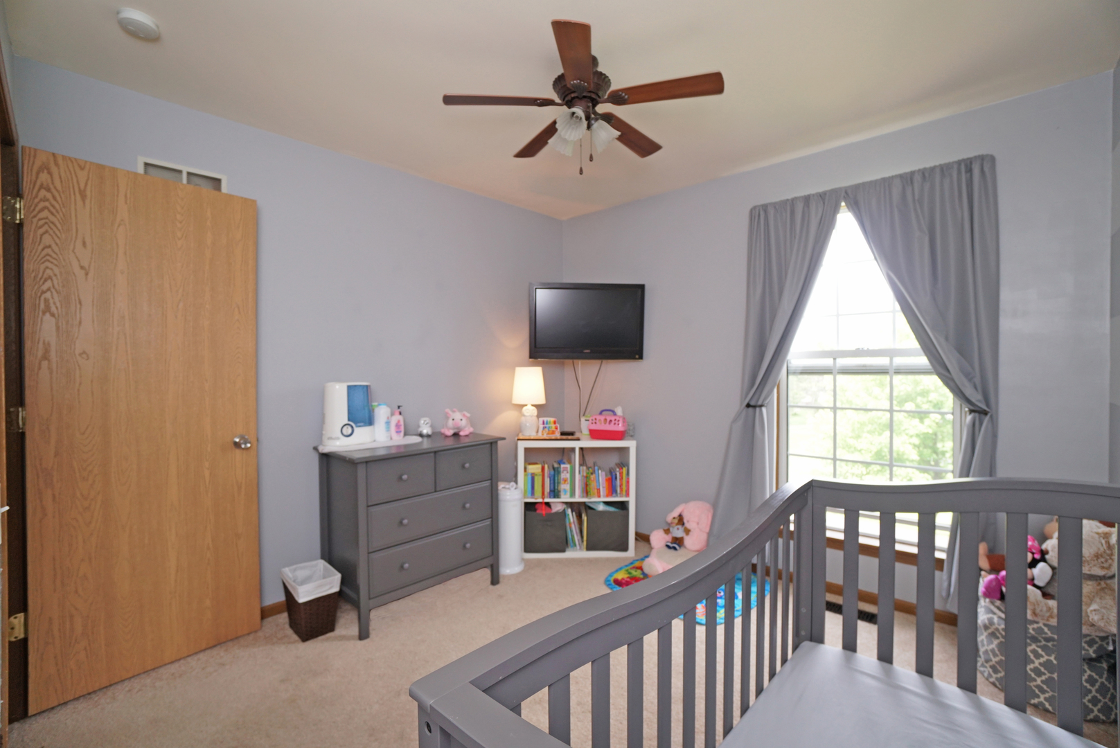 23 North Oltendorf Road Streamwood, IL 60107 - Photo 25 of 35 a living room with furniture a flat screen tv and a window