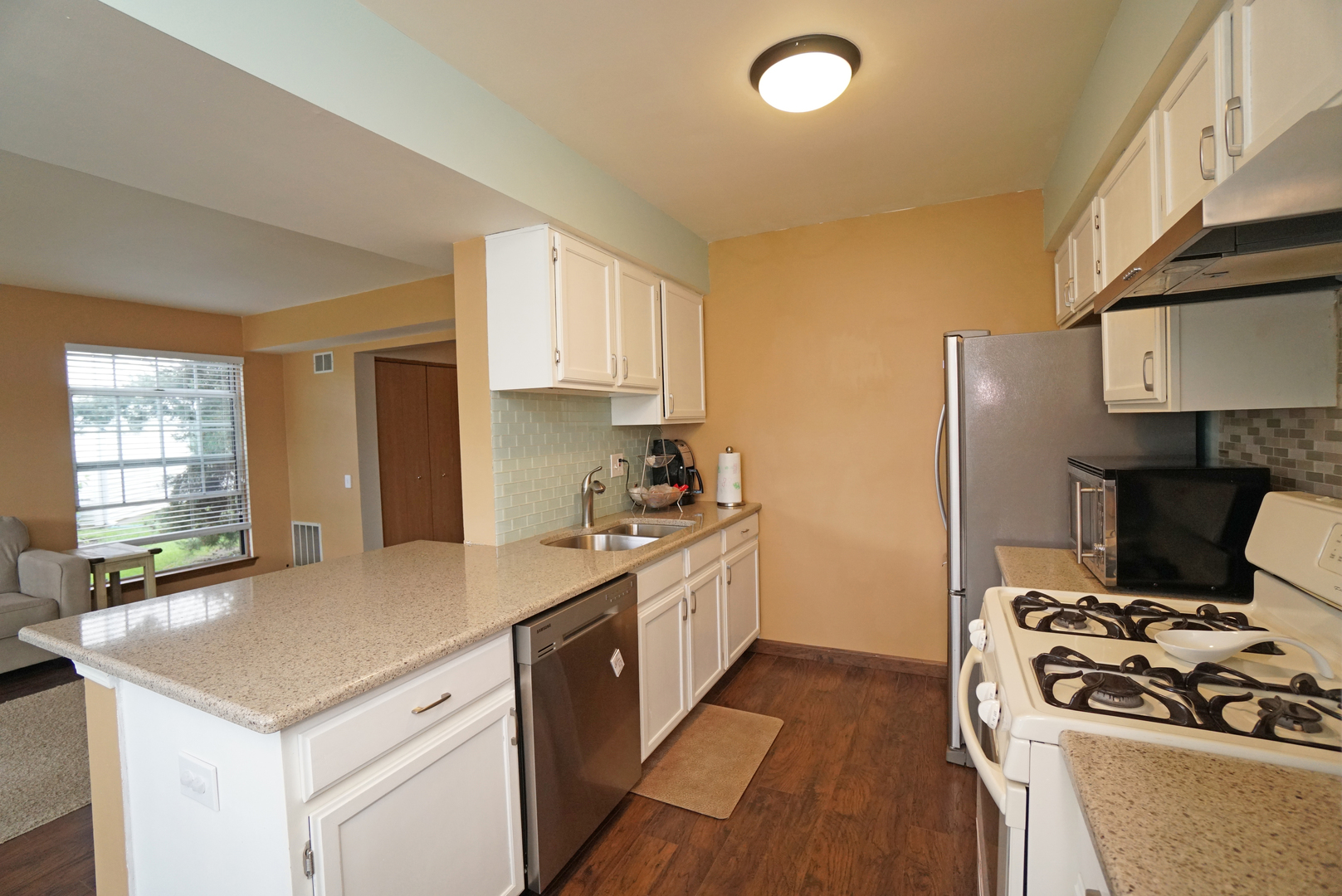 23 North Oltendorf Road Streamwood, IL 60107 - Photo 8 of 35 a kitchen with a stove a sink and a refrigerator