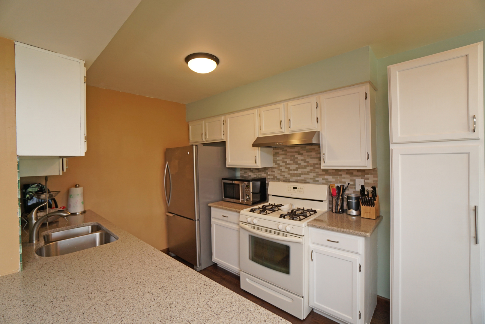 23 North Oltendorf Road Streamwood, IL 60107 - Photo 10 of 35 a kitchen with a refrigerator stove and white cabinets