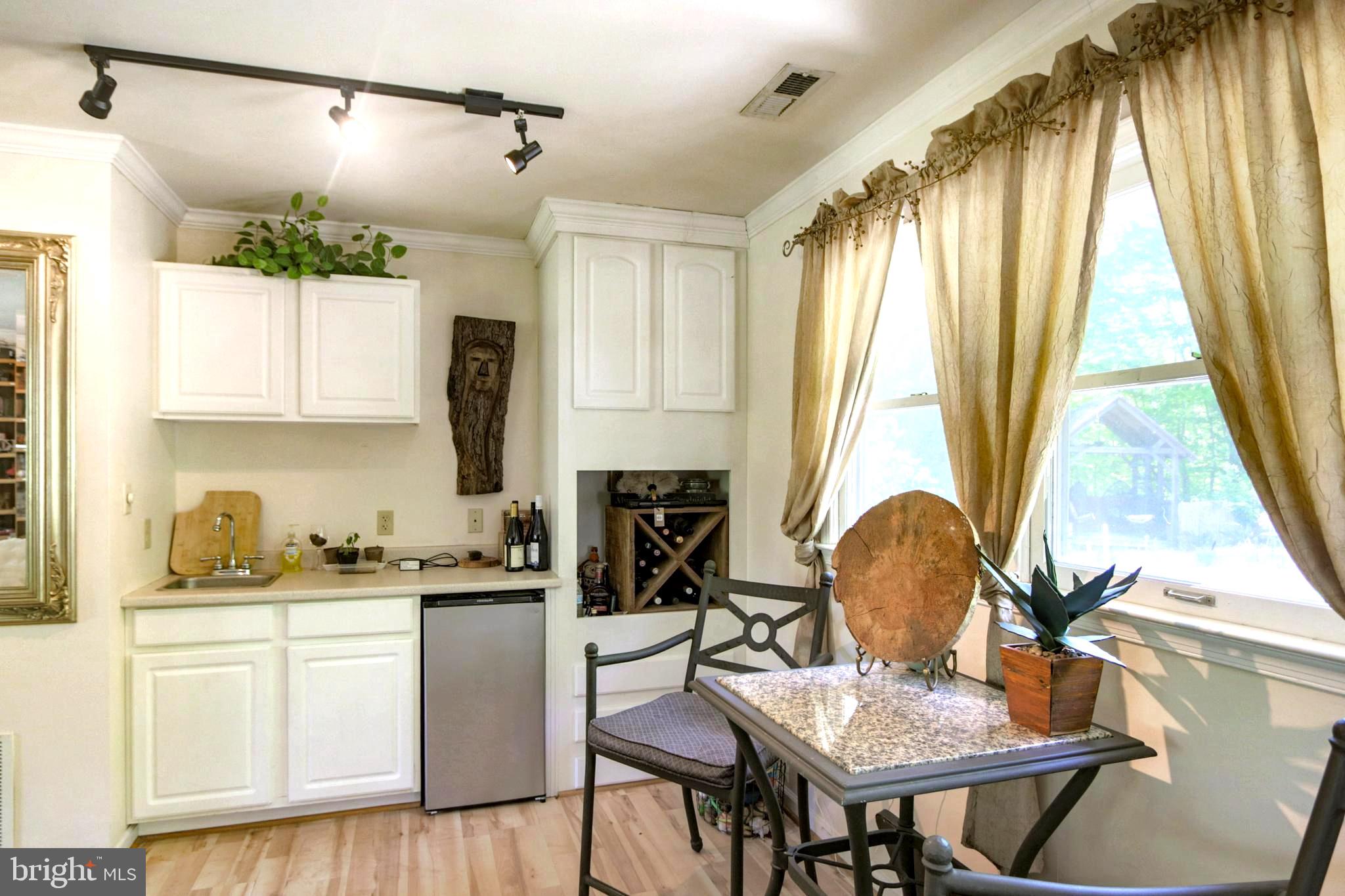 41 Wood Landing Road Fredericksburg, VA 22405 - Photo 6 of 54 a kitchen with a table chairs and a dining table