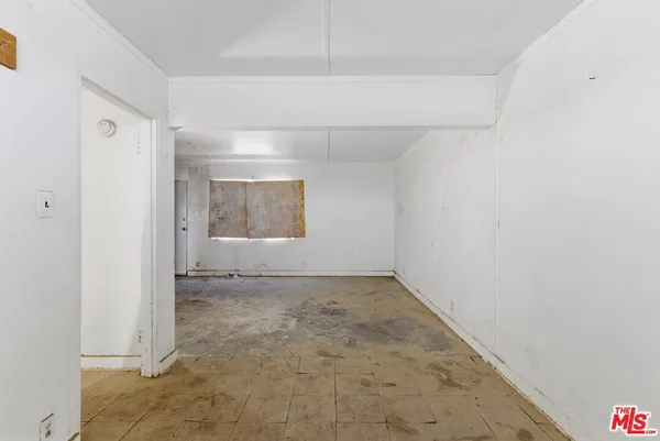 a view of a kitchen with white cabinets