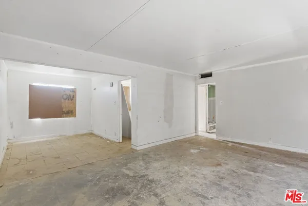 a view of a kitchen with white cabinets