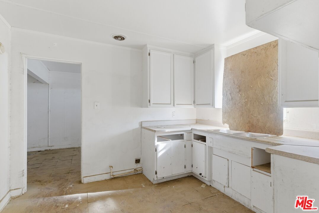 13879 Carson Street Trona, CA 93562 - Photo 23 of 29 a view of a kitchen with white cabinets