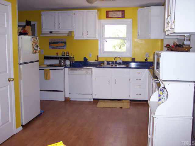 740 Capps Road Selma, NC 27576 - Photo 5 of 7 Bright and cheery kitchen with beautiful wood flooring.