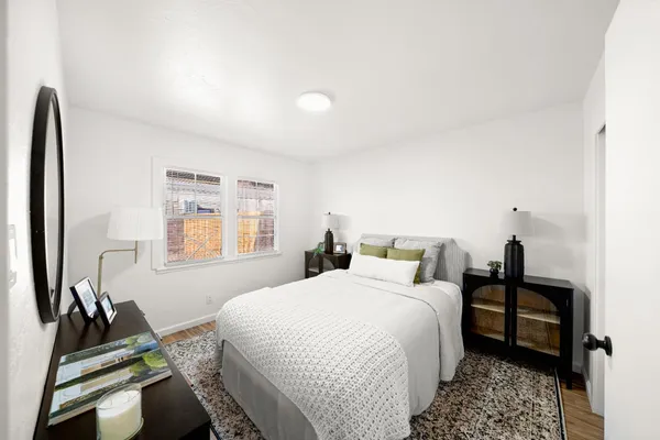 a bedroom with a bed and a window