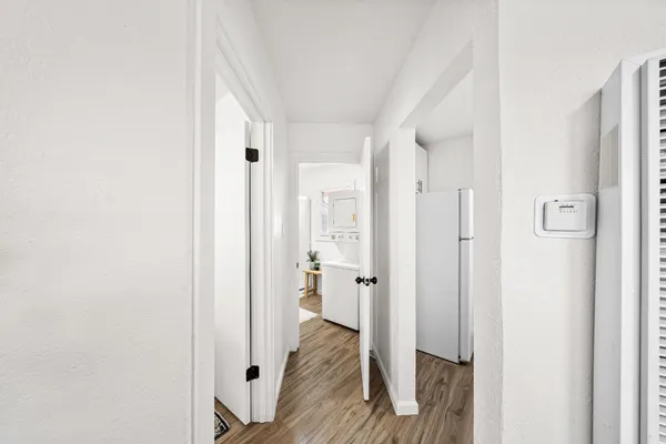a view of a room with wooden floor