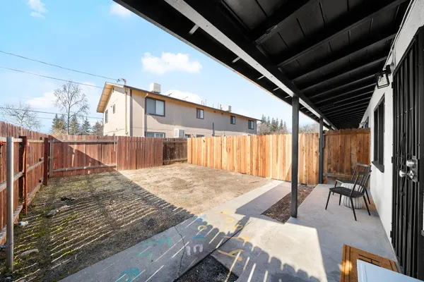 a view of a backyard with sitting area