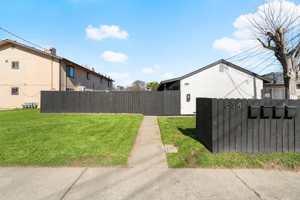 a view of backyard with seating and green space