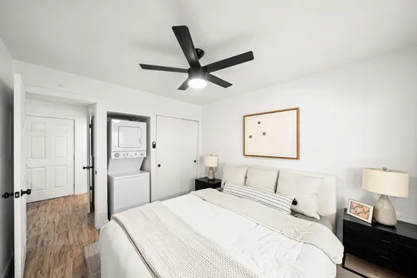 a bedroom with a bed and a painting on the wall