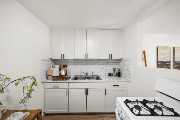 a living room with furniture and a white refrigerator