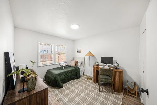 a bed room with a bed and a chair