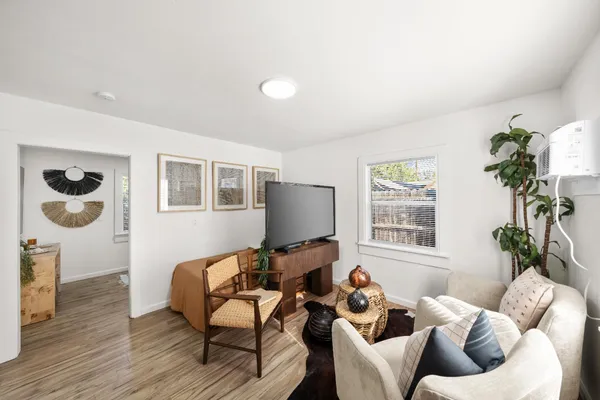 a living room with furniture and wooden floor