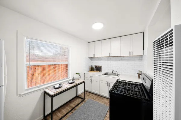 a kitchen that has a sink and a stove in it