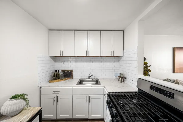 a kitchen with a sink and cabinets