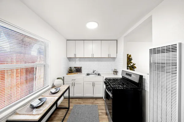 a kitchen with a sink stove and cabinets