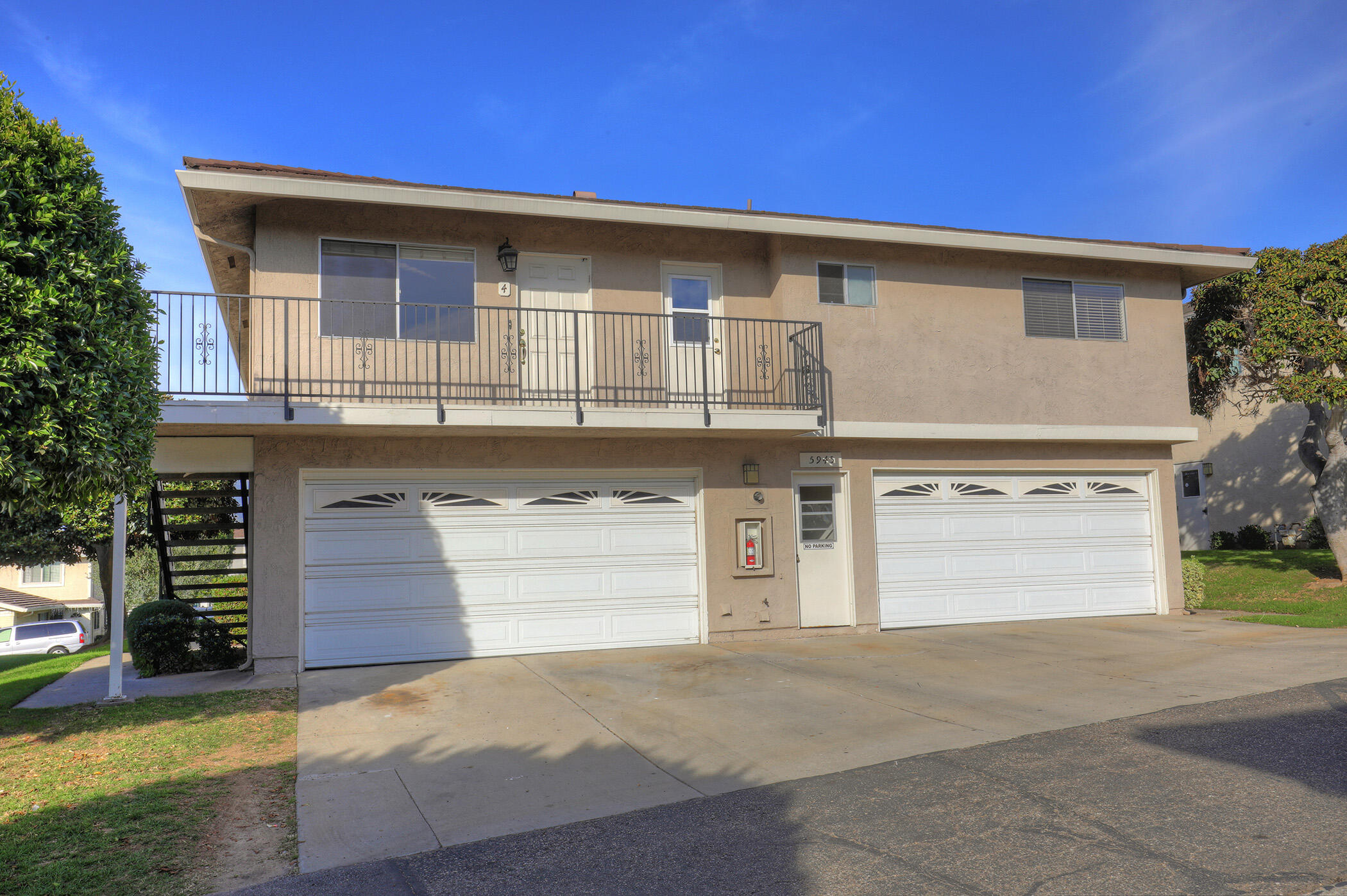 5945 Hickory Street, Unit 4 Carpinteria, CA 93013 - Photo 11 of 19 a front view of a house with a yard and garage