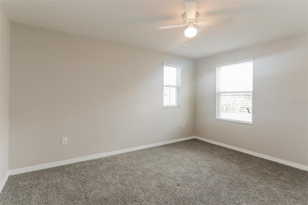 13628 Covey Run Place Spring Hill, FL 34609 - Photo 15 of 22 an empty room with a window and ceiling fan
