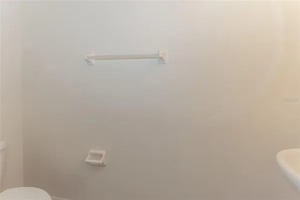 a bathroom with a granite countertop sink toilet mirror and shower