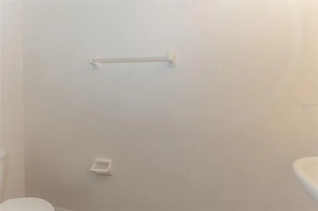 a bathroom with a granite countertop sink toilet mirror and shower